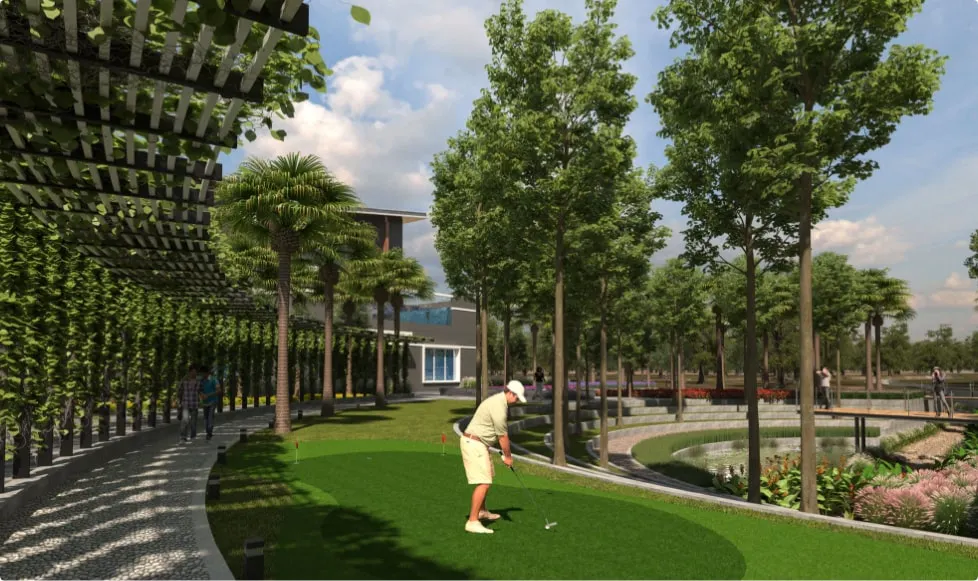 A man playing golf on a lush green putting green, surrounded by trees and a water feature, symbolizing the high-end leisure amenities and lifestyle offered at luxury residential projects in Bangalore by Mana Projects